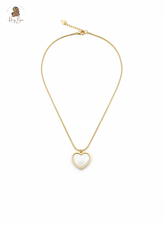 Gold heart-shaped pendant necklace on a white background