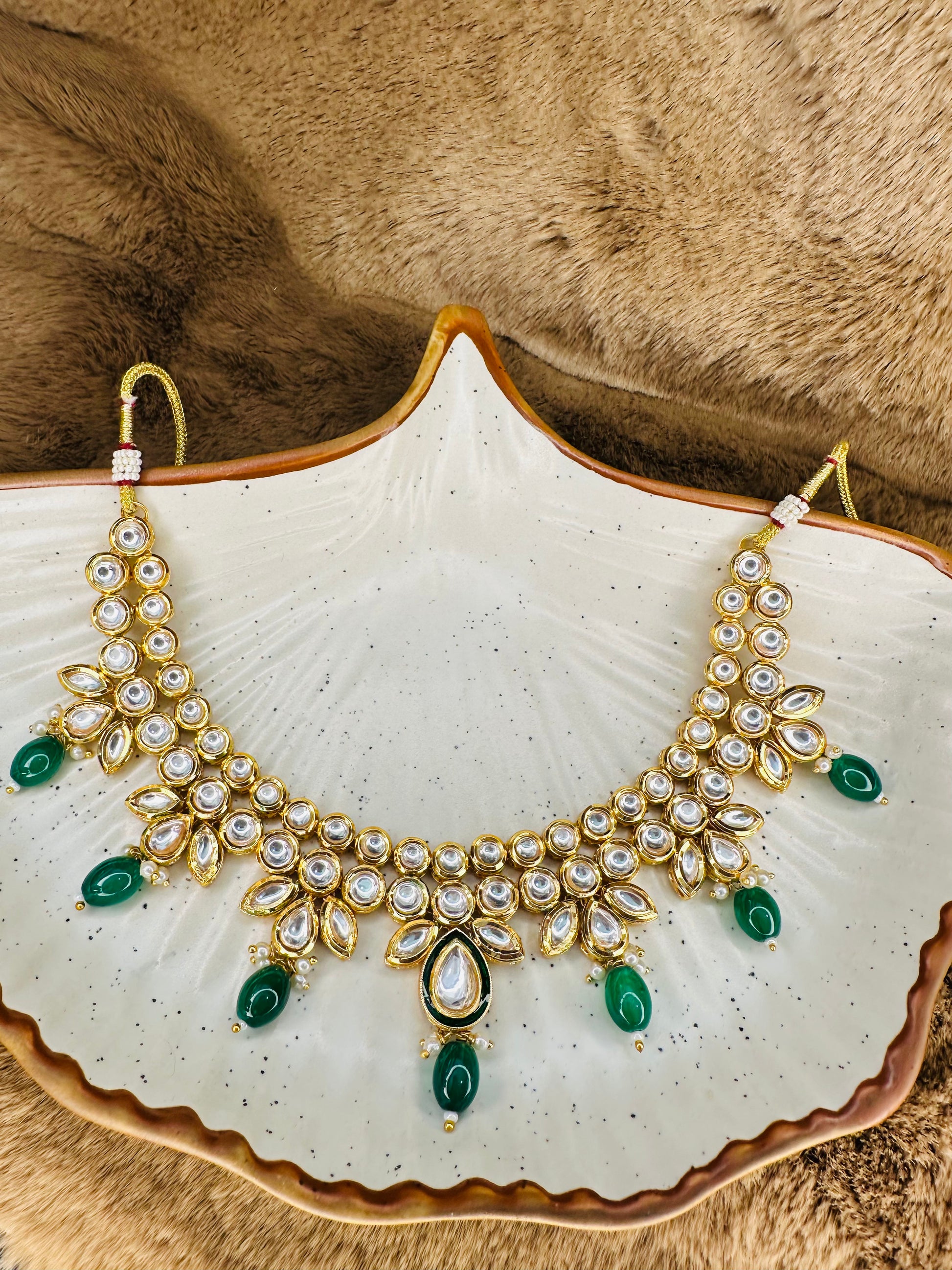 Detailed close-up of kundan choker and earrings