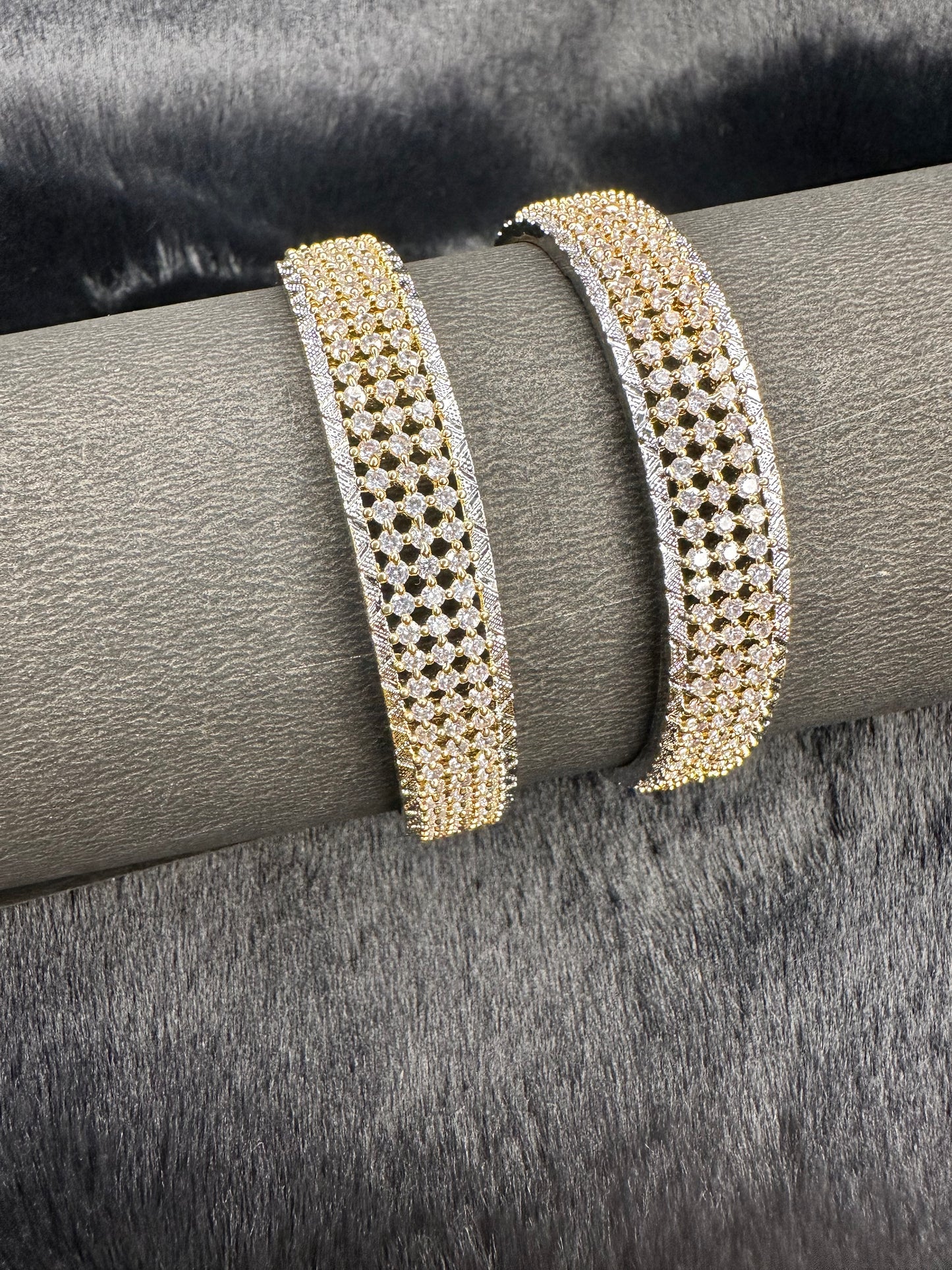 Flat lay of HeyBae Gold AD Designer Bangles with sparkling American Diamonds on fabric background