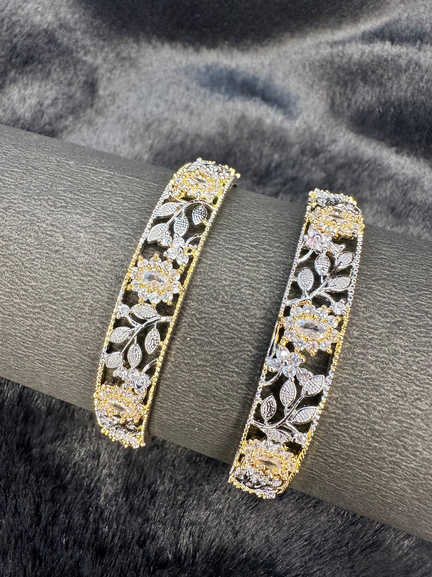 Flat lay of HeyBae AD bangles set on decorative cloth