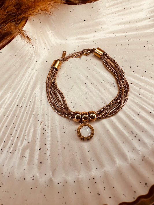 Adjustable stainless steel gold bracelet with black and white charms