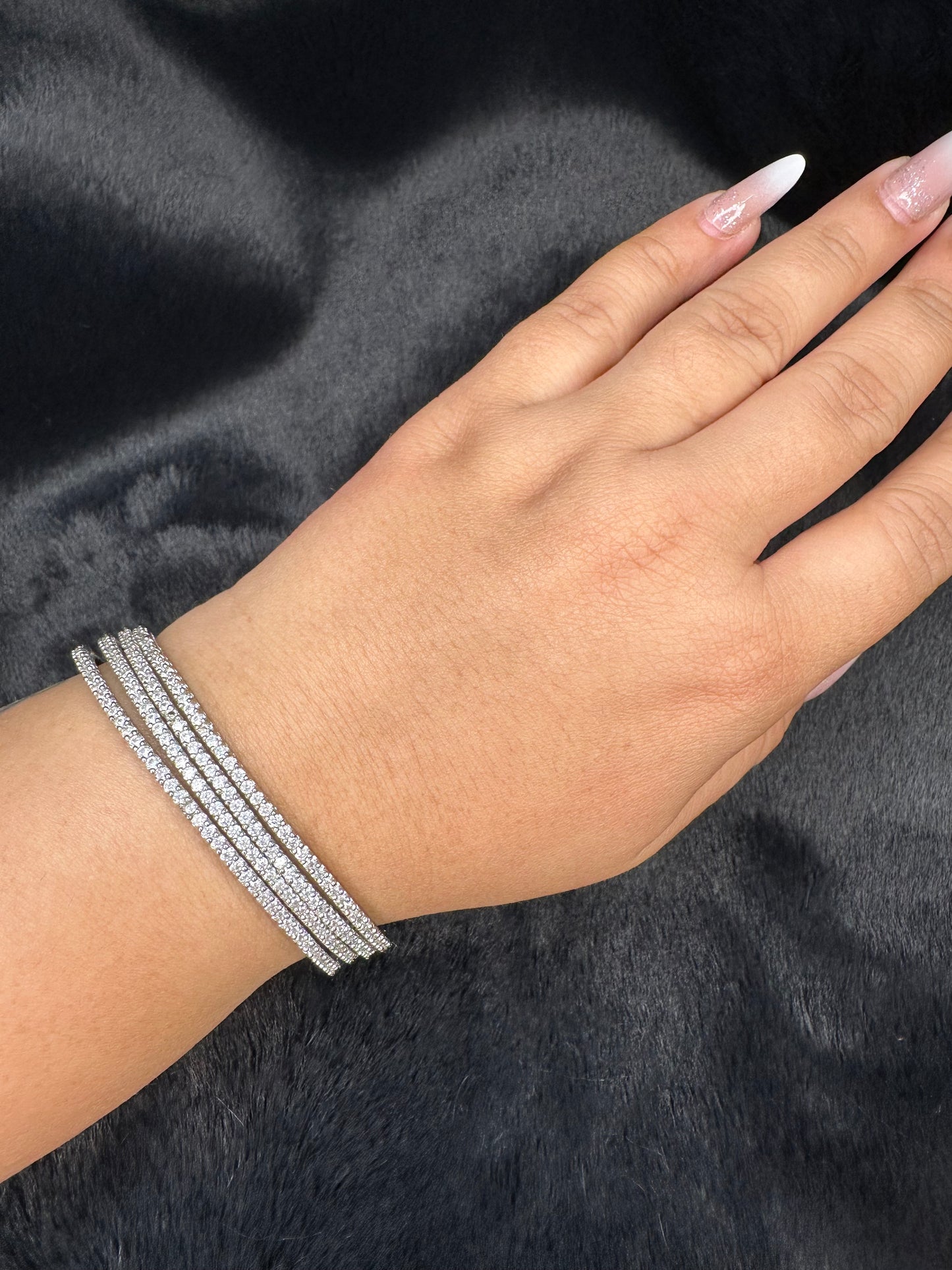 Side angle shot of American Diamond bangles set of 4 with sparkling stones