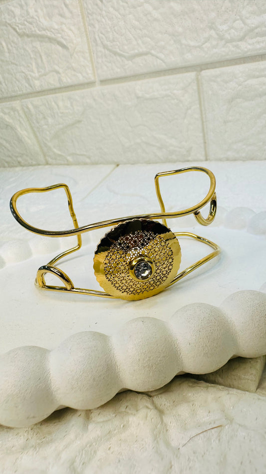 Side angle of gold disc cuff bracelet with open kada adjustable frame