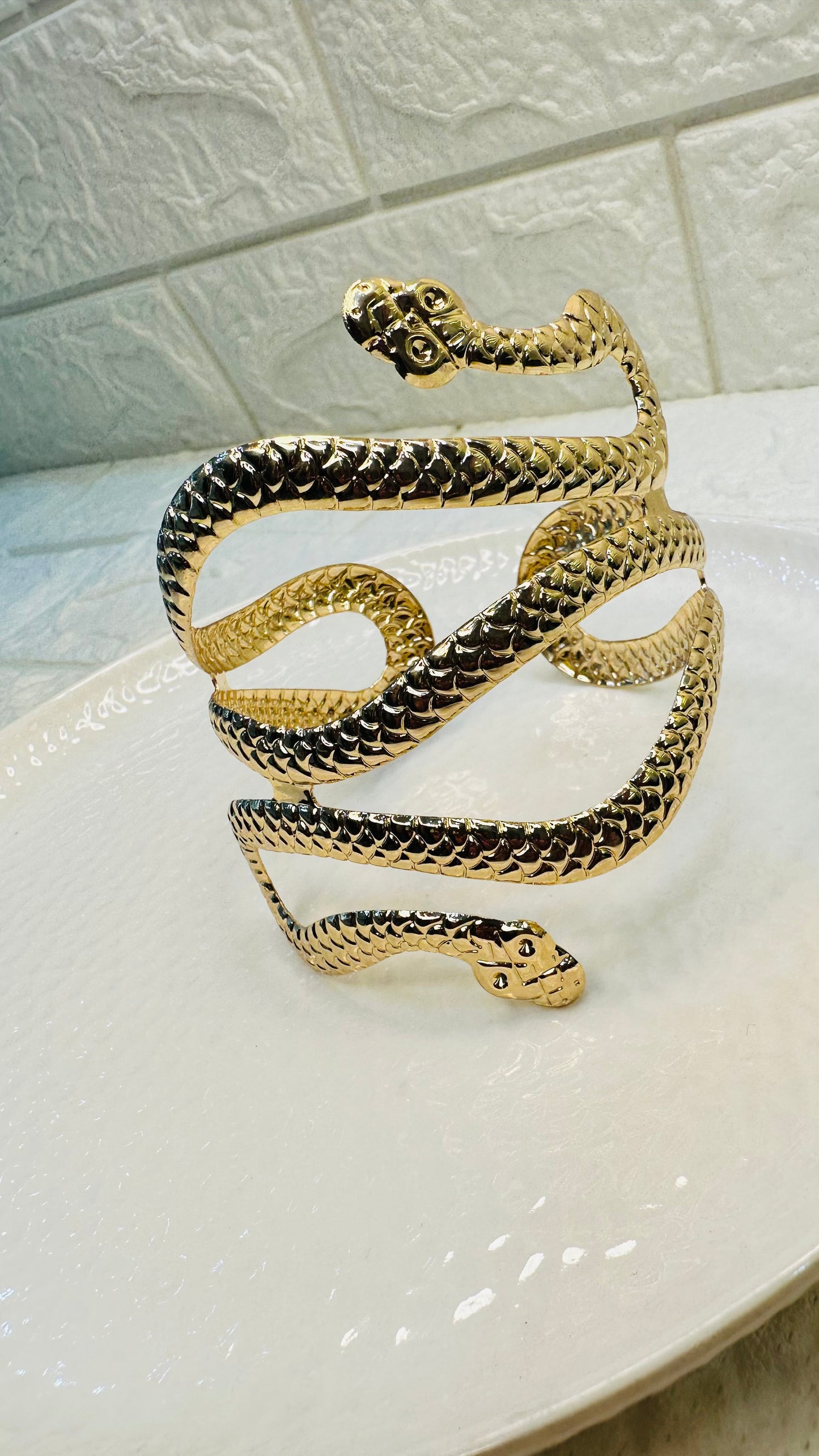 Gold snake cuff bracelet styled on hand for festive and party wear