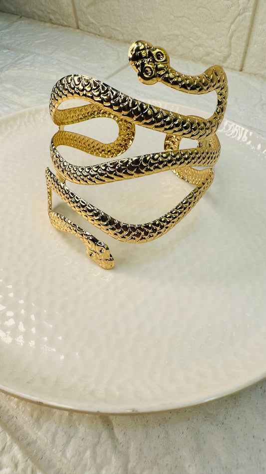 Side profile of gold snake cuff bracelet with scale texture
