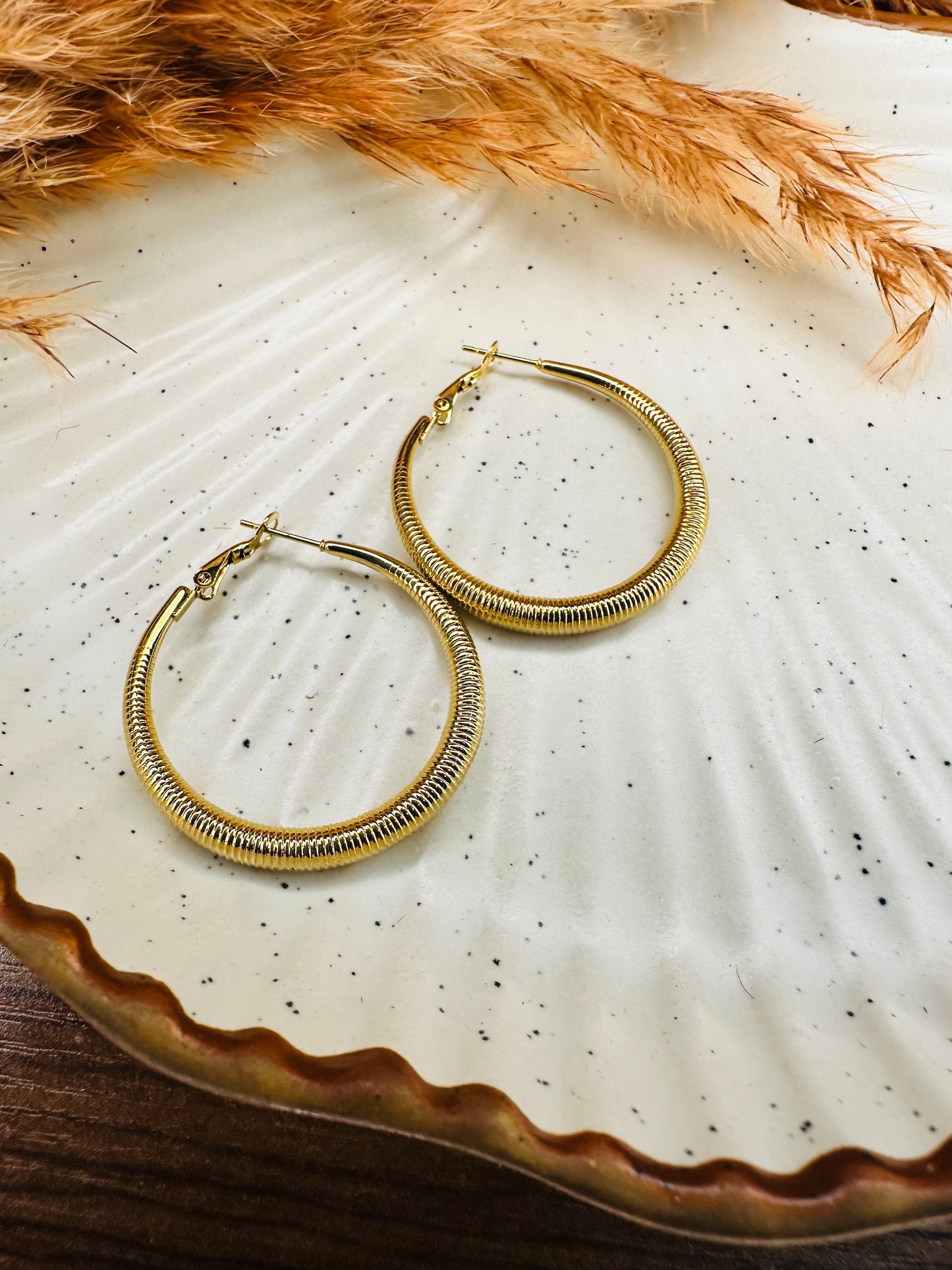 Premium HeyBae gold hoop earrings with radiant polished finish