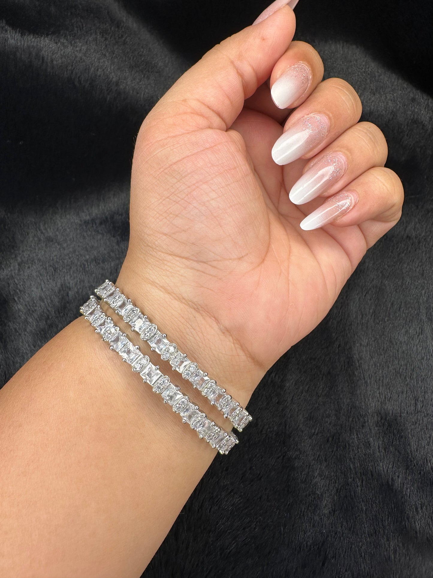 Flat lay image of HeyBae Sparkling Silver AD Bangle on fabric background