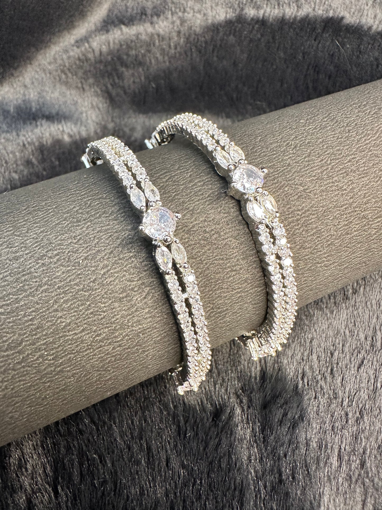 tack of HeyBae silver and gold bangles