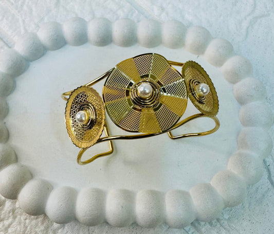 Top view of statement pearl cuff bracelet in gold finish