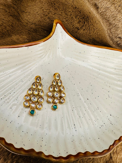 Necklace on display dish, kundan + green beads