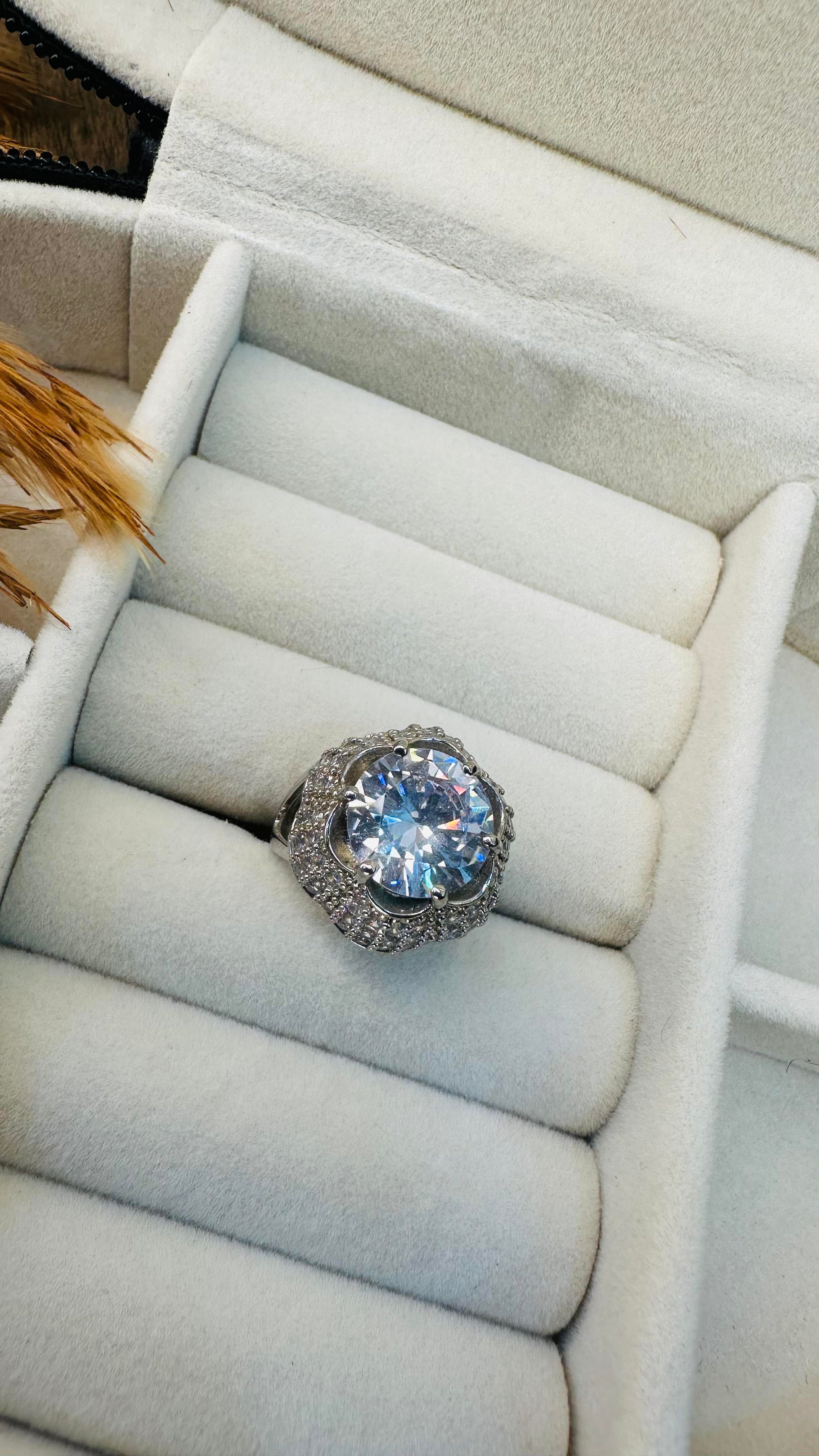 Prong-set large solitaire with pave halo ring