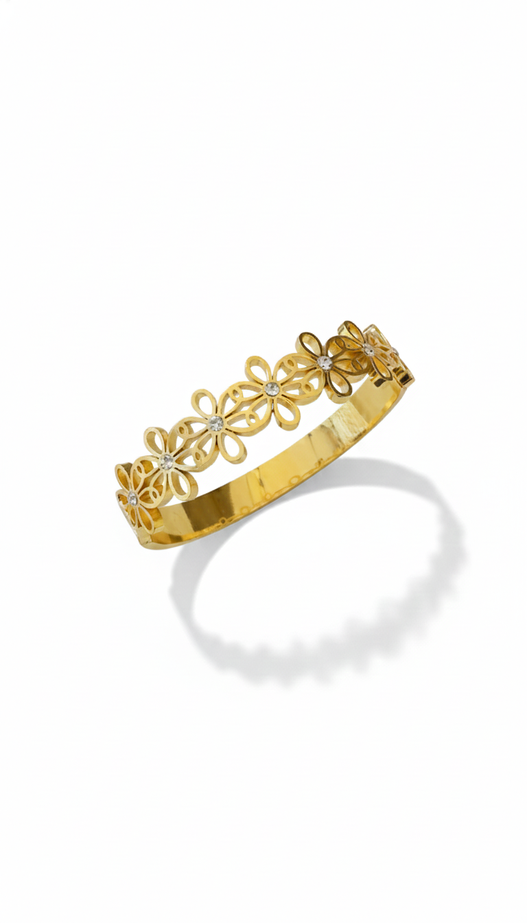 Gold bracelet with floral designs on a white background