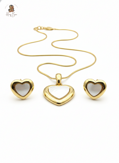 Gold heart-shaped jewelry set on a white background
