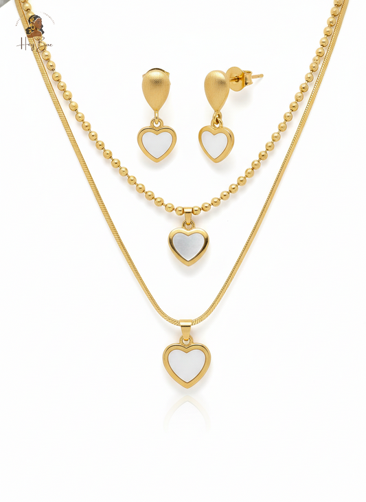 Gold heart-shaped jewelry set with necklace and earrings on a white background