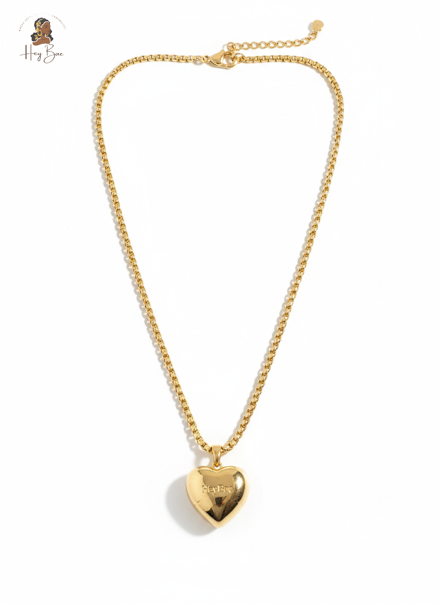 Gold heart-shaped pendant necklace on a white background