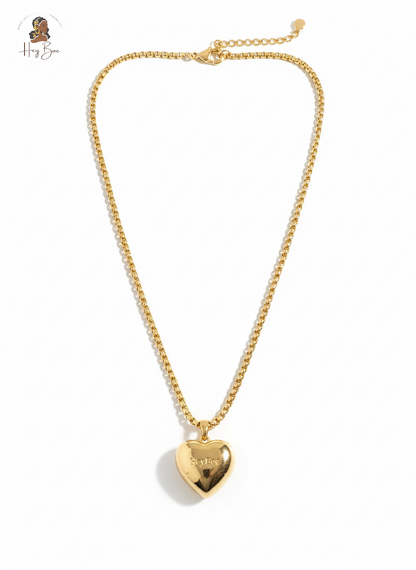Gold heart-shaped pendant necklace on a white background