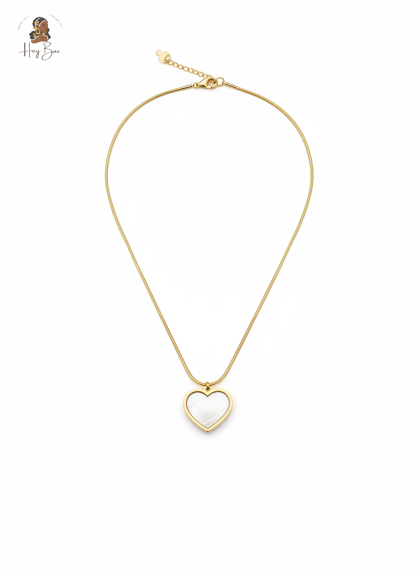 Gold heart-shaped pendant necklace on a white background