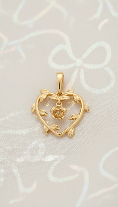 Gold heart-shaped pendant with a rose design on a light background