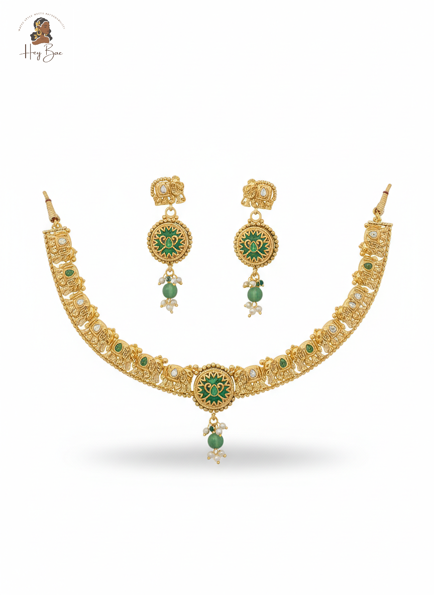 Gold necklace with green gemstones on a white background