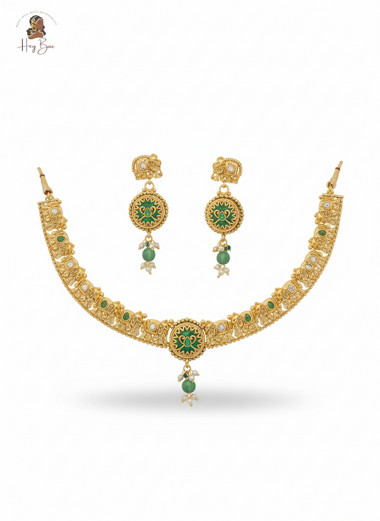 Gold necklace with green gemstones on a white background