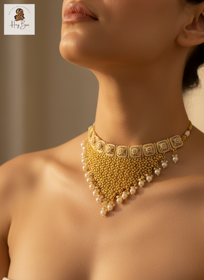 Gold necklace with pearls worn by a model against a neutral background