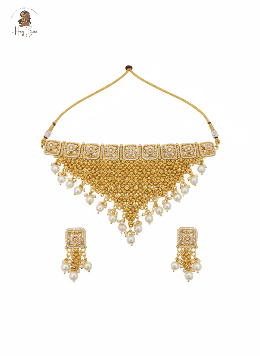 Gold necklace with white beads on a white background