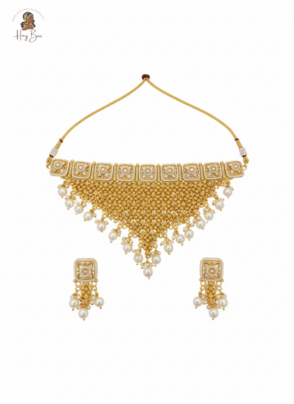 Gold necklace with white beads on a white background
