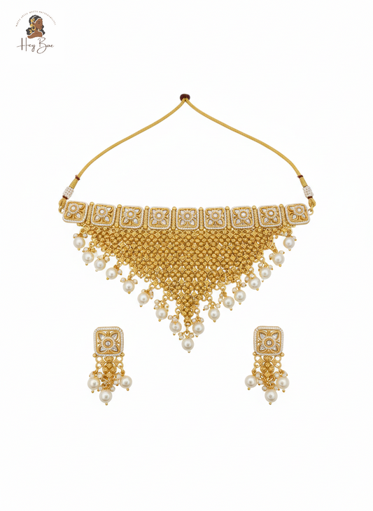 Gold necklace with white beads on a white background