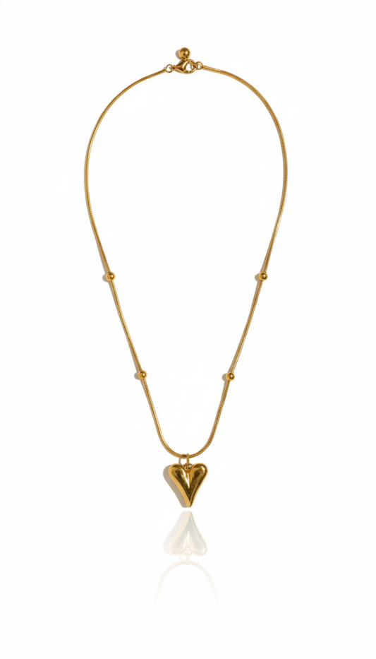 Gold heart pendent with a heart-shaped pendant on a white background