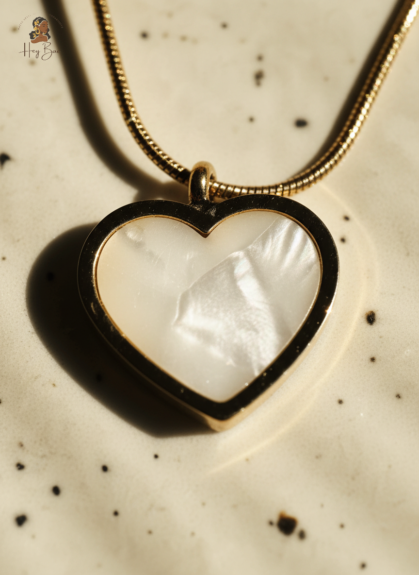 Heart-shaped pendant with a white stone on a speckled surface