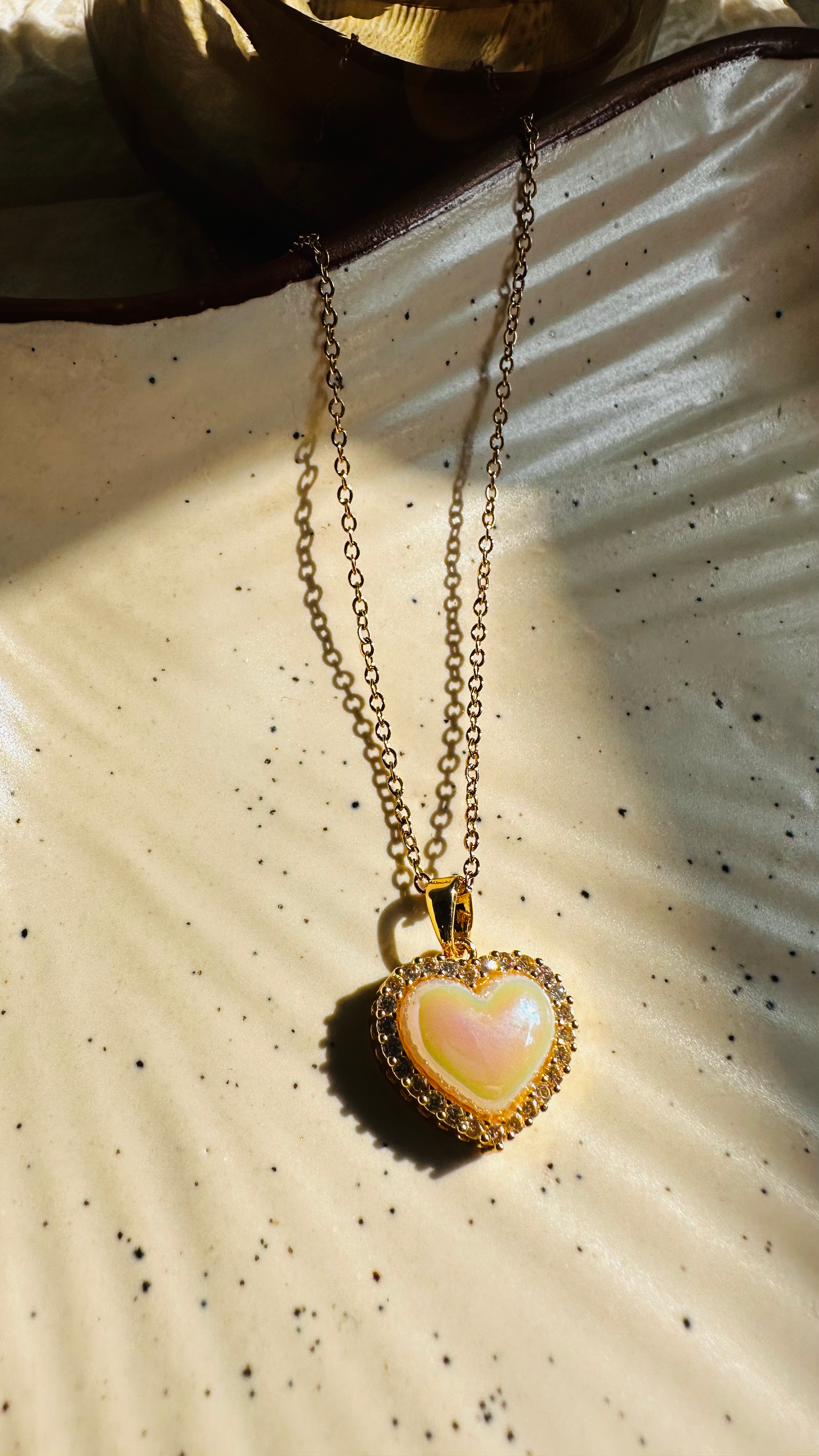Heart-shaped pendant necklace on a textured surface