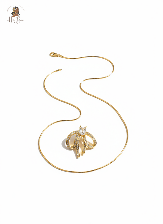 Gold necklace with a pendant on a white background