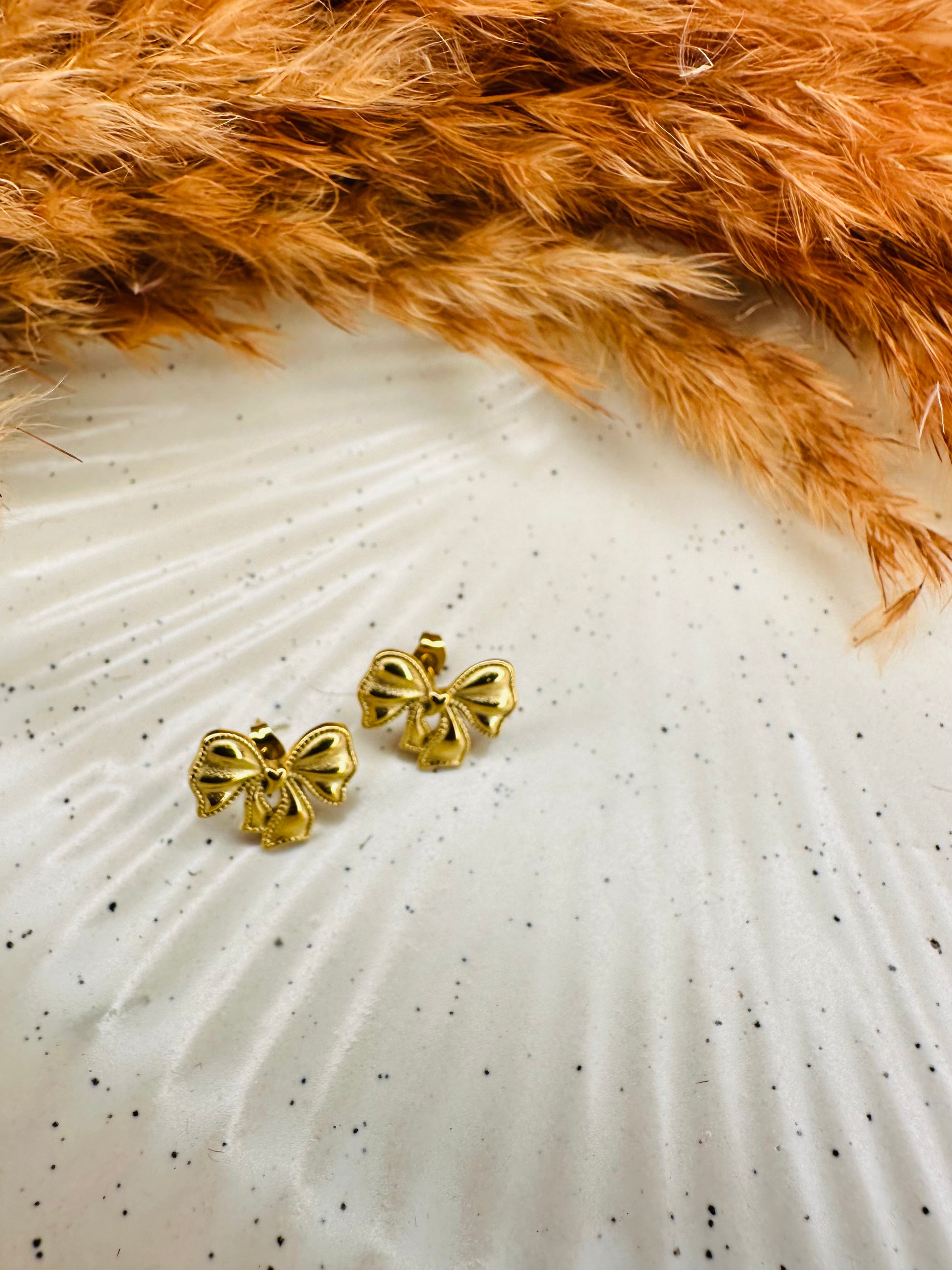 Stylish gold bow stud earrings with premium finish by HeyBae