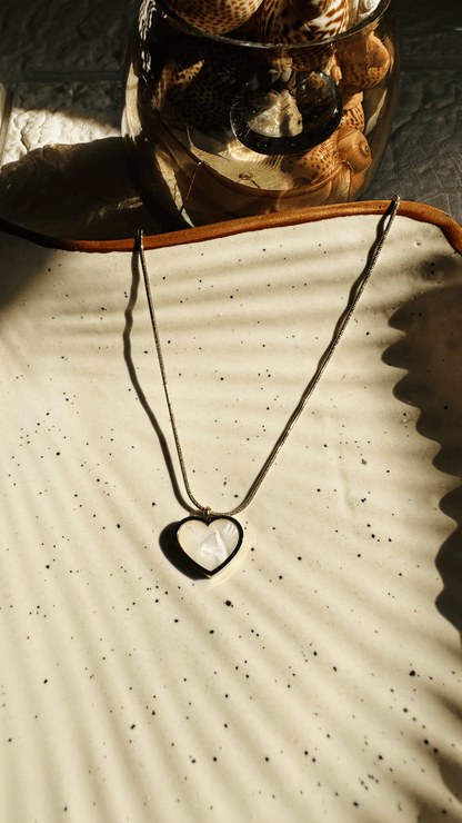 Necklace with a heart pendant on a textured surface