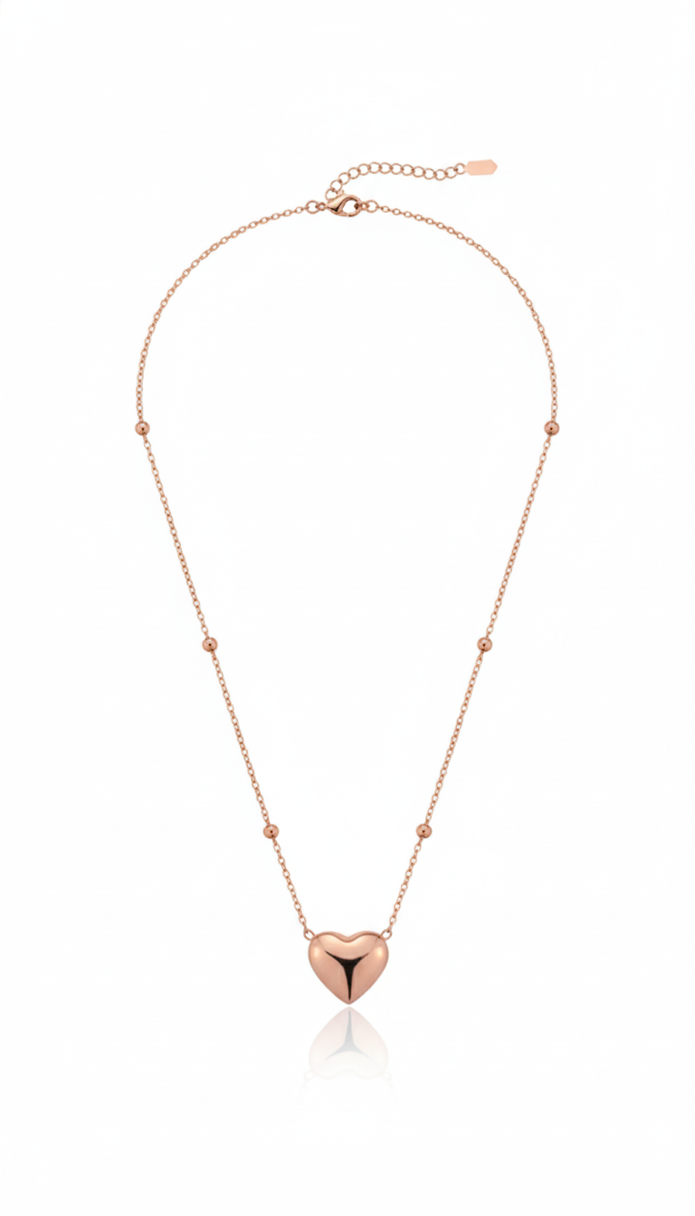 Rose gold necklace with a heart-shaped pendant on a white background