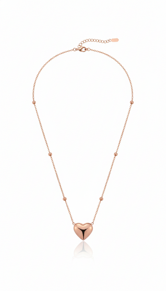 Rose gold necklace with a heart-shaped pendant on a white background