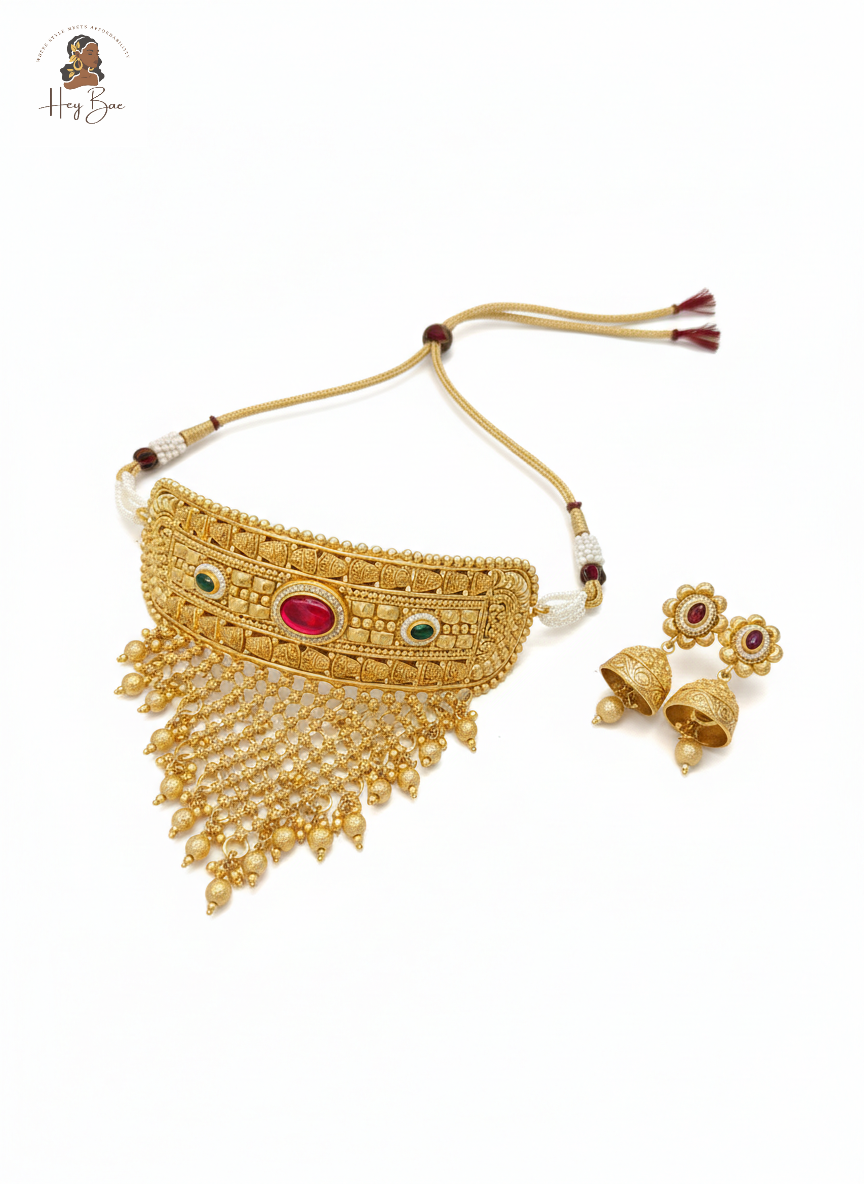 Royal Rajwadi antique gold choker necklace set with red and green stones on white background.
