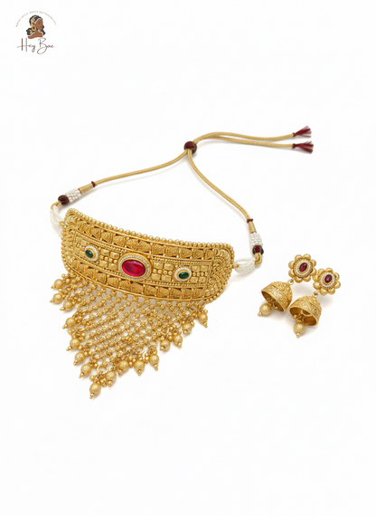 Royal Rajwadi antique gold choker necklace set with red and green stones on white background.