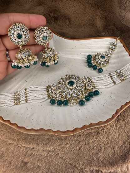 Intricate gold detailing with red Kundan stones & pearls