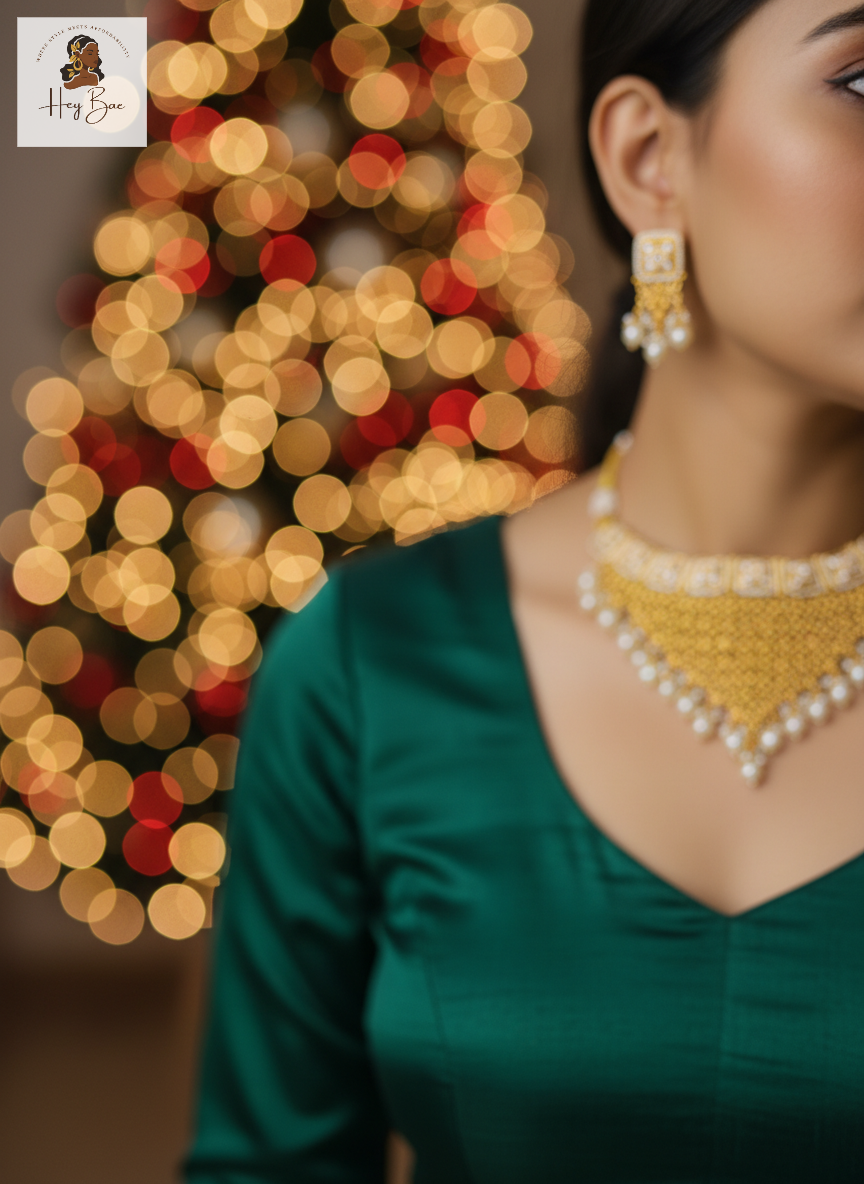 Woman wearing gold jewelry with a blurred festive background