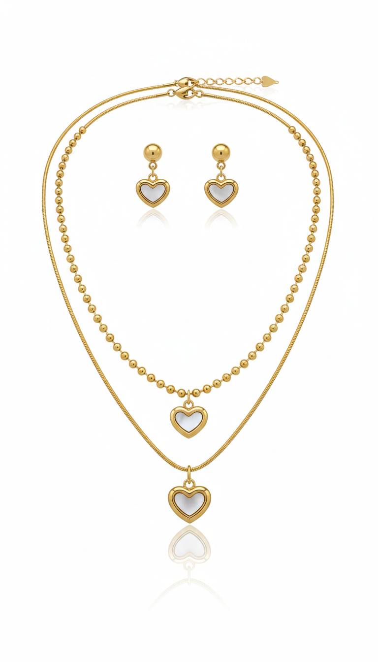 Gold necklace and earrings with heart pendants on a white background