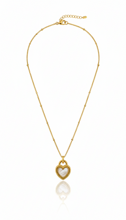 Gold necklace with a heart-shaped pendant on a white background