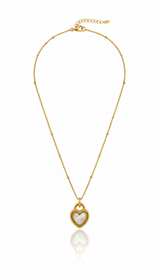 Gold necklace with a heart-shaped pendant on a white background