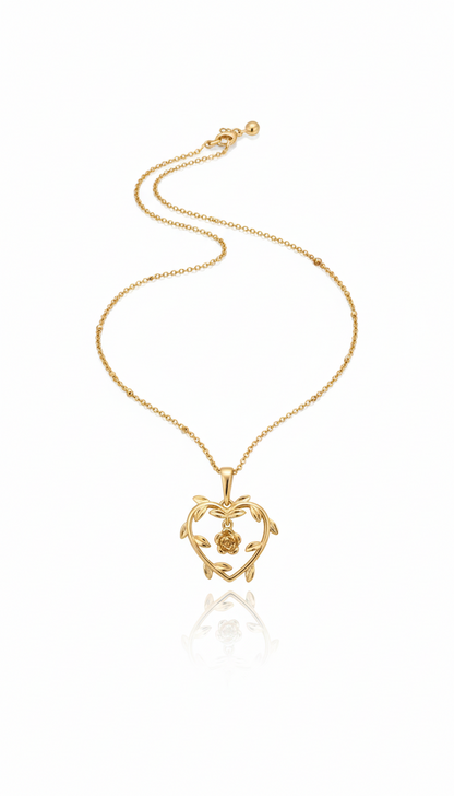 Gold necklace with a heart-shaped pendant on a white background