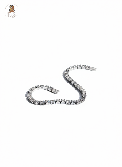 Silver bracelet with clear stones on a white background