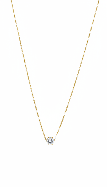 Gold necklace with a small diamond pendant on a white background