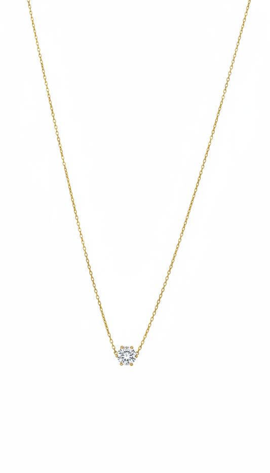 Gold necklace with a small diamond pendant on a white background