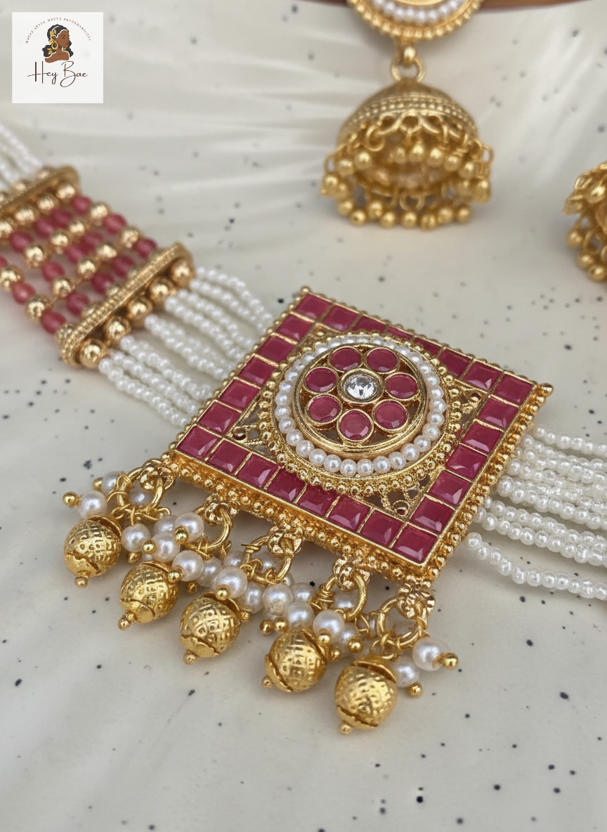 hey bae Royal Ruby Pearl Choker Set with Jhumkas - Gold Plated on a textured white background