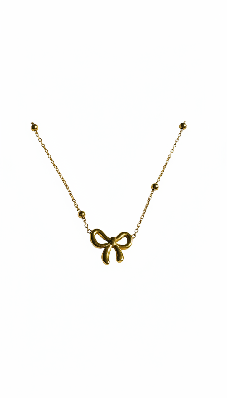 Gold bow-shaped necklace on a white background