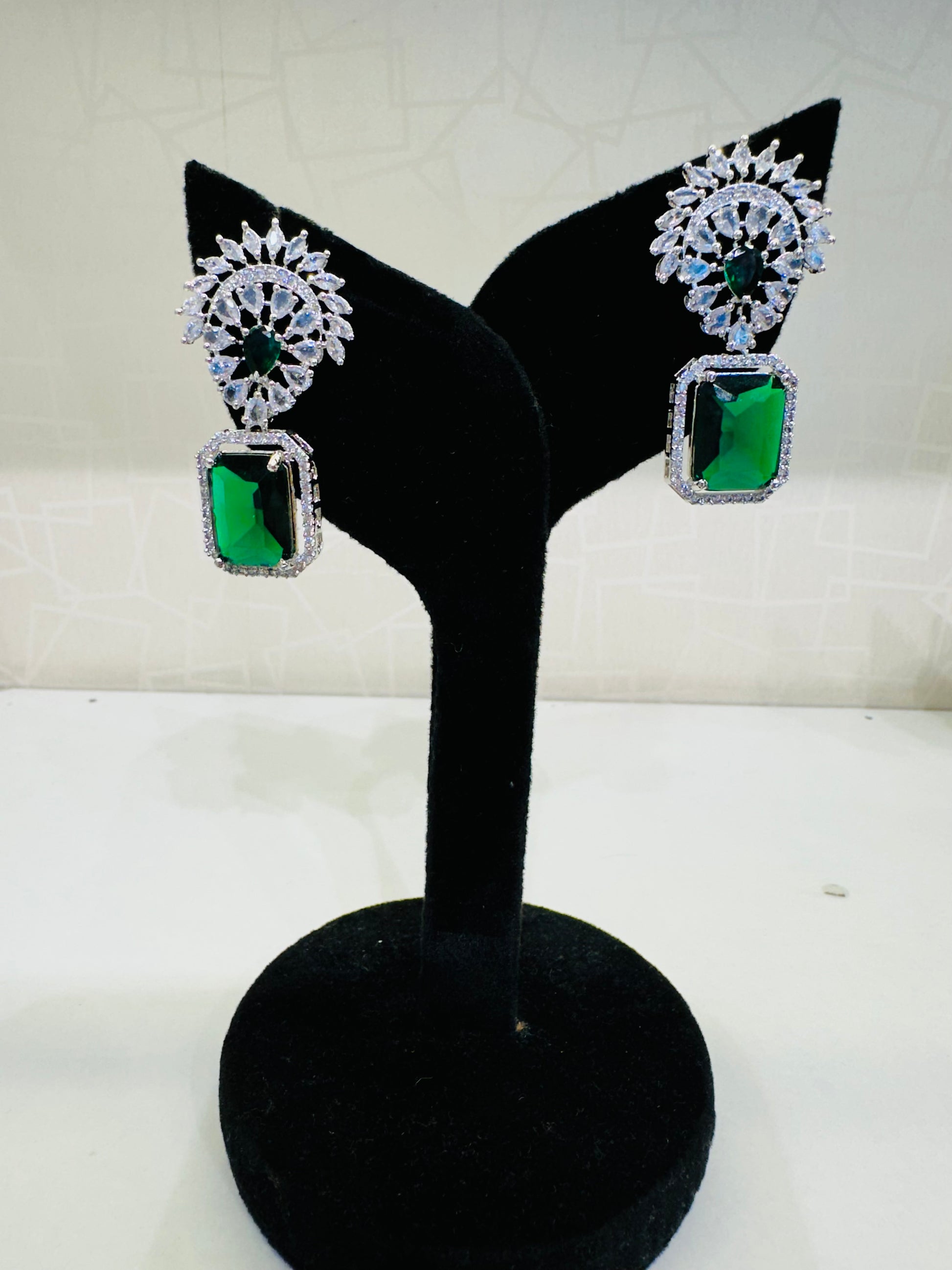 Side angle of HeyBae AD Stud Drop Stone Earrings with polished finish